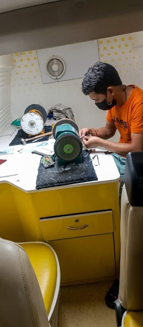 Grinding and buffing wheels set up inside the mobile workshop
